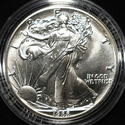 1988 AMERICAN SILVER EAGLE. BID WITH SILVER CITY AUCTIONS ESTIMATE $110 - $160.