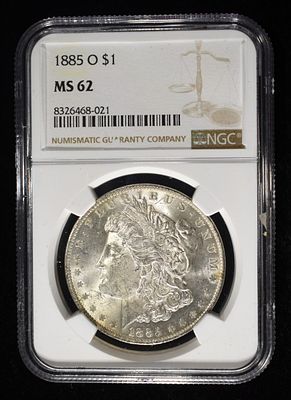 1885-O MORGAN DOLLAR NGC MS62. BID WITH SILVER CITY AUCTIONS ESTIMATE $120 - $170.