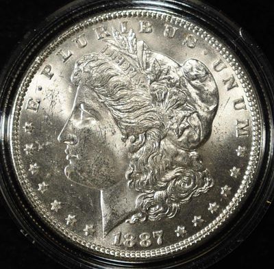 1887 MORGAN DOLLAR CH BU. CHECK OUT OUR UPCOMING AUCTIONS ESTIMATE $100 - $130.