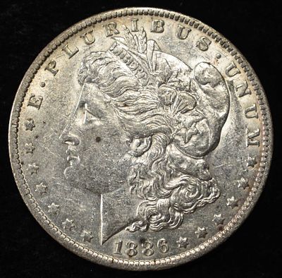 1886-O MORGAN DOLLAR AU. BID WITH SILVER CITY AUCTIONS ESTIMATE $170 - $200.