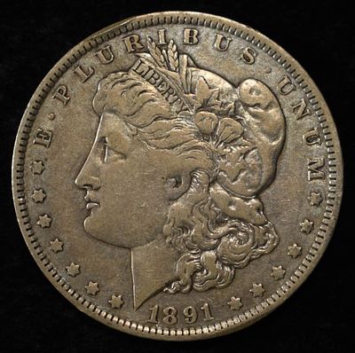 1891-O MORGAN DOLLAR. BID WITH SILVER CITY AUCTIONS ESTIMATE $90 - $130.