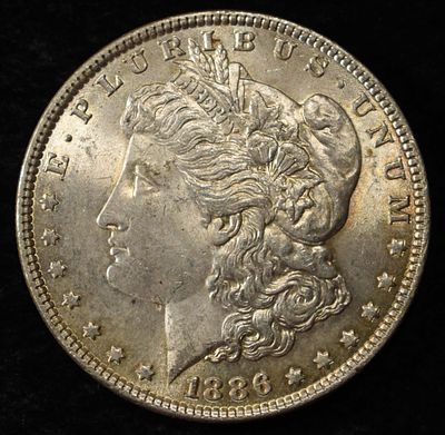 1886 MORGAN DOLLAR. BID WITH SILVER CITY AUCTIONS ESTIMATE $90 - $130.