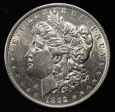 1892 MORGAN DOLLAR UNC. CHECK OUT OUR UPCOMING AUCTIONS ESTIMATE $450 - $500.