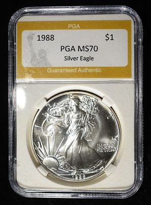 1988 AMERICAN SILVER EAGLE PGA PERFECT GEM BU. CHECK OUT OUR UPCOMING AUCTIONS ESTIMATE $100 - $150.