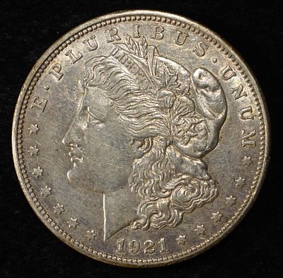 1921-D MORGAN DOLLAR. CHECK OUT OUR UPCOMING AUCTIONS ESTIMATE $90 - $130.