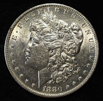 1880-O MORGAN DOLLAR AU/BU. CHECK OUT OUR UPCOMING AUCTIONS ESTIMATE $120 - $150.