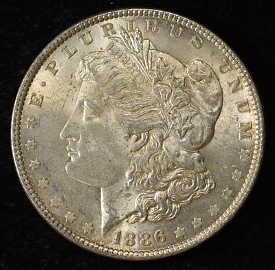 1886 MORGAN DOLLAR. LEADERS IN ON-LINE AUCTIONS ESTIMATE $90 - $130.