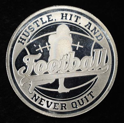 FOOTBALL 1 OZ .999 SILVER ROUND. WEEKLY COIN & CURRENCY AUCTIONS ESTIMATE $120 - $170.