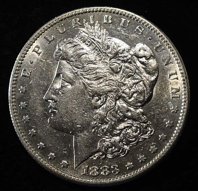 1883-S MORGAN DOLLAR AU/BU. BID WITH SILVER CITY AUCTIONS ESTIMATE $600 - $700.