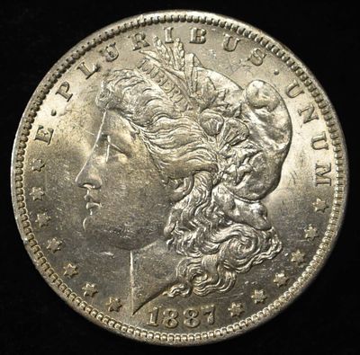 1887-O MORGAN DOLLAR BU. CHECK OUT OUR UPCOMING AUCTIONS ESTIMATE $200 - $300.