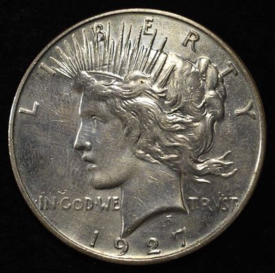 1927-D PEACE DOLLAR AU/BU. CHECK OUT OUR UPCOMING AUCTIONS ESTIMATE $300 - $400.