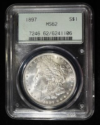 1897 MORGAN DOLLAR PCGS MS-62 OLD GREEN HOLDER. CHECK OUT OUR UPCOMING AUCTIONS ESTIMATE $130 - $150.