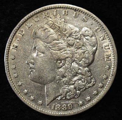 1889-O MORGAN DOLLAR. CHECK OUT OUR UPCOMING AUCTIONS ESTIMATE $80 - $120.
