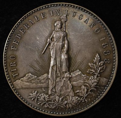1883 SWISS SHOOTING MEDAL LUGANO SILVER. CHECK OUT OUR UPCOMING AUCTIONS ESTIMATE $400 - $500.