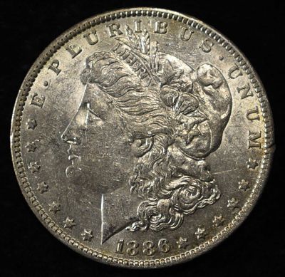 1886-O MORGAN DOLLAR AU. LEADERS IN ON-LINE AUCTIONS ESTIMATE $170 - $200.