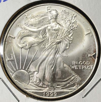 1999 AMERICAN SILVER EAGLE. BID WITH SILVER CITY AUCTIONS ESTIMATE $100 - $150.