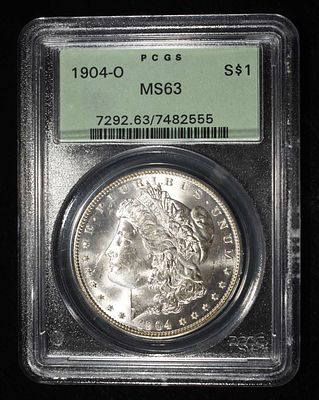 1904-O MORGAN DOLLAR PCGS MS-63 OLD GREEN HOLDER. BID WITH SILVER CITY AUCTIONS ESTIMATE $130 - $150.