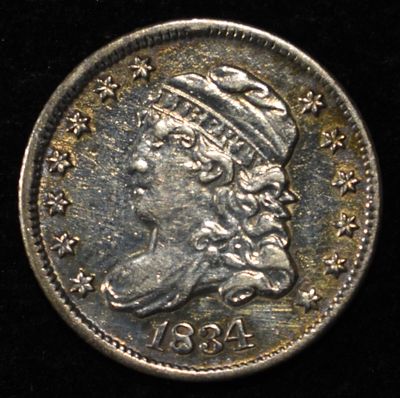 1834 BUST HALF DIME AU. BID WITH SILVER CITY AUCTIONS ESTIMATE $250 - $300.