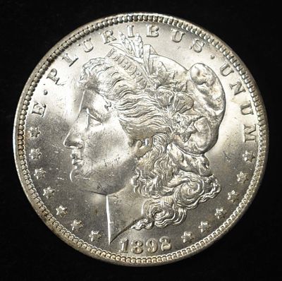 1892-O MORGAN DOLLAR CH BU. BID WITH SILVER CITY AUCTIONS ESTIMATE $700 - $800.
