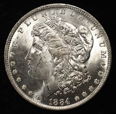 1884-O MORGAN DOLLAR BU. CHECK OUT OUR UPCOMING AUCTIONS ESTIMATE $130 - $150.