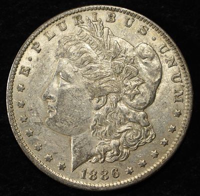 1886-O MORGAN DOLLAR AU. BID WITH SILVER CITY AUCTIONS ESTIMATE $200 - $250.