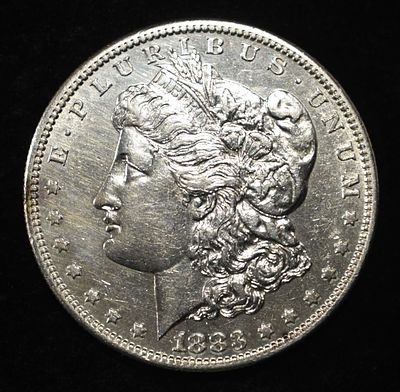 1883-S MORGAN DOLLAR AU/BU. BID WITH SILVER CITY AUCTIONS ESTIMATE $600 - $700.