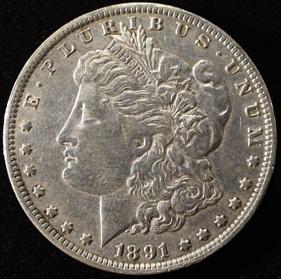 1891-O MORGAN DOLLAR XF/AU. BID WITH SILVER CITY AUCTIONS ESTIMATE $130 - $150.