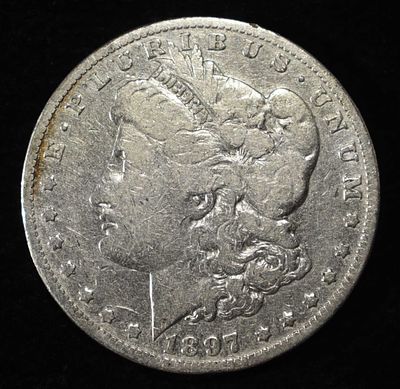 1897-O MORGAN DOLLAR. BID WITH SILVER CITY AUCTIONS ESTIMATE $90 - $130.