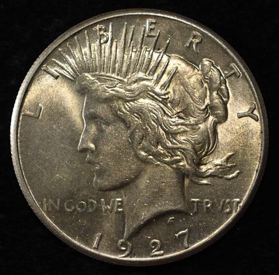 1927 PEACE DOLLAR AU/BU. BID WITH SILVER CITY AUCTIONS ESTIMATE $130 - $150.