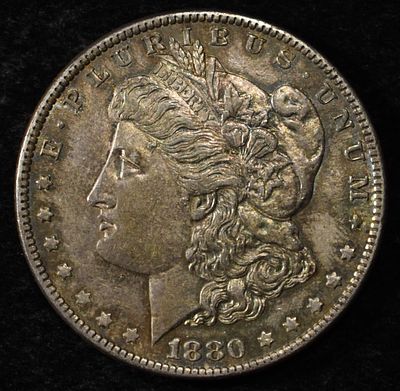 1880-O MORGAN DOLLAR BU TONED. BID WITH SILVER CITY AUCTIONS ESTIMATE $130 - $150.