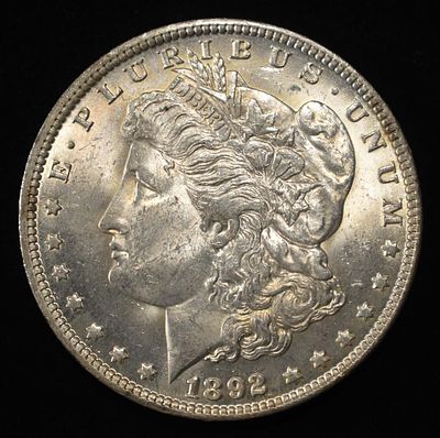 1892-O MORGAN DOLLAR BU. BID WITH SILVER CITY AUCTIONS ESTIMATE $450 - $550.