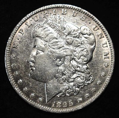 1895-O MORGAN DOLLAR AU. CHECK OUT OUR UPCOMING AUCTIONS ESTIMATE $2050 - $2150.