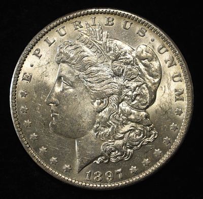 1897-O MORGAN DOLLAR BU. BID WITH SILVER CITY AUCTIONS ESTIMATE $1200 - $1400.