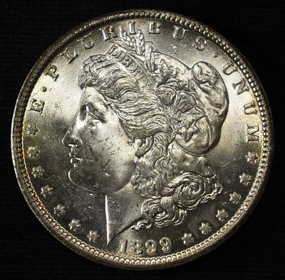 1899-O MORGAN DOLLAR CH BU. CHECK OUT OUR UPCOMING AUCTIONS ESTIMATE $130 - $150.