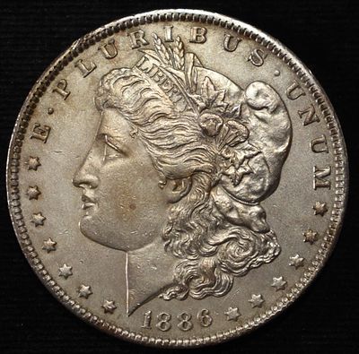 1886-O MORGAN DOLLAR SHARP UNC OLD CLEANING. LEADERS IN ON-LINE AUCTIONS ESTIMATE $1300 - $1400.
