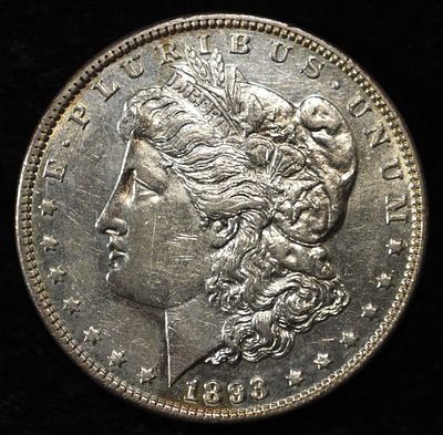 1893 MORGAN DOLLAR AU/BU. CHECK OUT OUR UPCOMING AUCTIONS ESTIMATE $1300 - $1500.