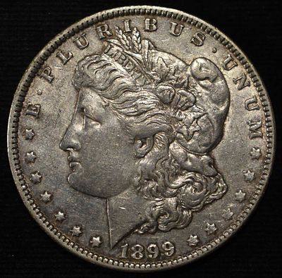1899-O MICRO 'O' MORGAN DOLLAR AU. BID WITH SILVER CITY AUCTIONS ESTIMATE $160 - $210.
