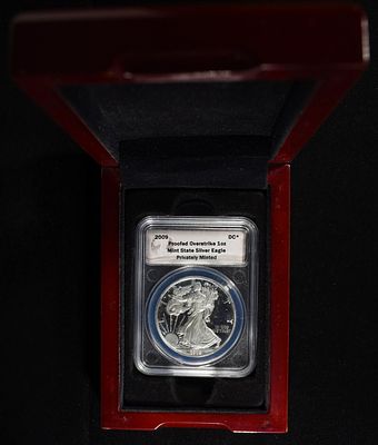2009 AMERICAN SILVER EAGLE OVERSTRIKE PRIVATELY MI. LEADERS IN ON-LINE AUCTIONS ESTIMATE $130 - $180.