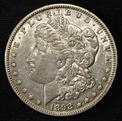 1892-O MORGAN DOLLAR XF/AU. BID WITH SILVER CITY AUCTIONS ESTIMATE $130 - $150.