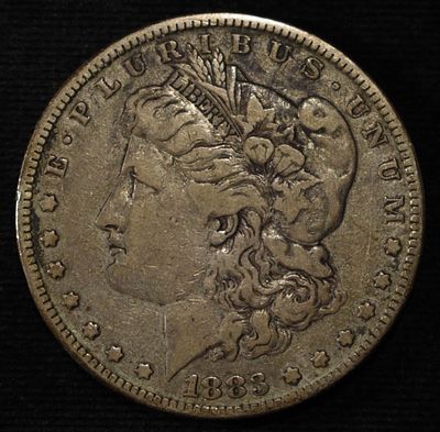 1883 MORGAN DOLLAR. BID WITH SILVER CITY AUCTIONS ESTIMATE $75 - $100.
