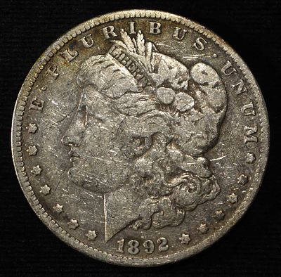 1892-O MORGAN DOLLAR. TOP RATED AUCTION HOUSE ESTIMATE $75 - $100.