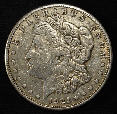 1921-S MORGAN DOLLAR. CHECK OUT OUR UPCOMING AUCTIONS ESTIMATE $75 - $100.