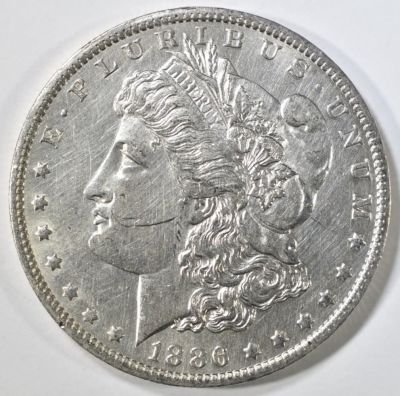 1886-O MORGAN DOLLAR AU/BU MARK ON CHEEK. LEADERS IN ON-LINE AUCTIONS ESTIMATE $300 - $350.