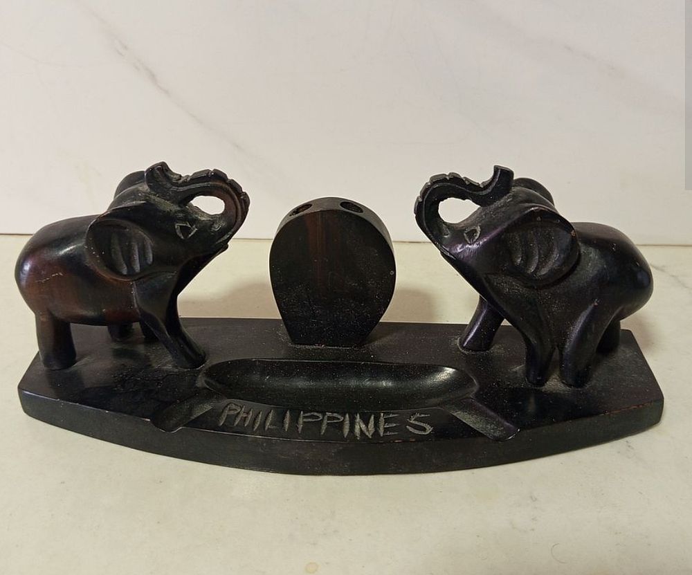 מעמד שולחני זוג פילים 
עבודת יד עץ ריבוני 
משמש לכלי כתיבה 
גובה 10 ס''מ רוחב 25 סמ