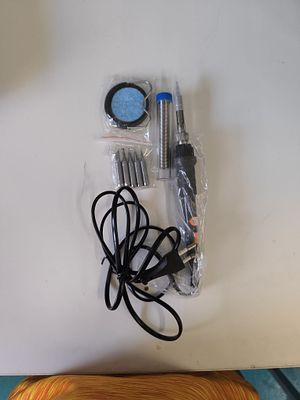 A Lot of Four Items: A Modern Soldering Kit with European Plug and Associated Packaging. This 