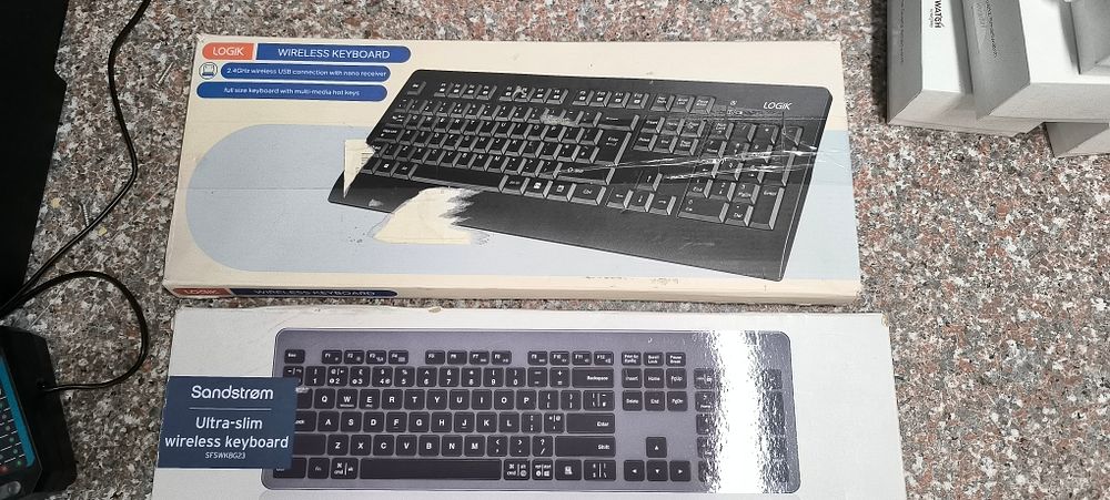 LOGIK Wireless Multimedia Keyboard 2.4 GHz LCMMKB23 and a Sandstrom Ultra-slim Wireless Keyboard. 