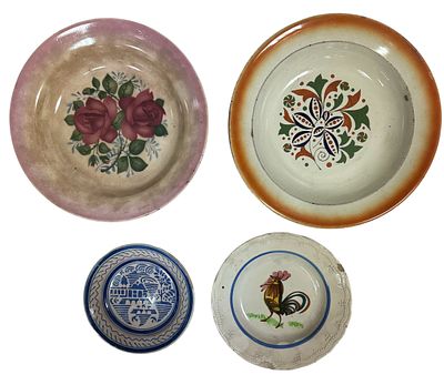 4 Antique earthenware plates, polychrome decoration with flowers and other motifs. With small flaws.