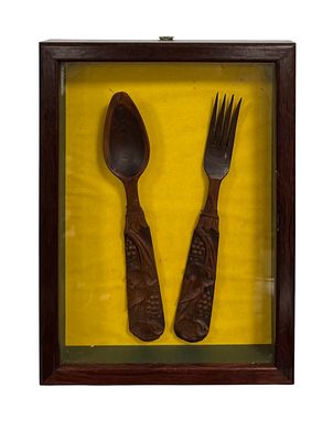 Set of wooden fork and spoon with carved details, featuring vines and grapes. African art. Framed.