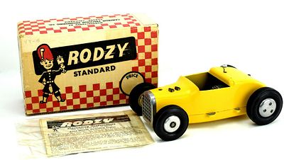 A CAMERON RODZY TETHER CAR WITH MOTOR AND ORIGINAL BOX. The yellow body with aluminum grill 