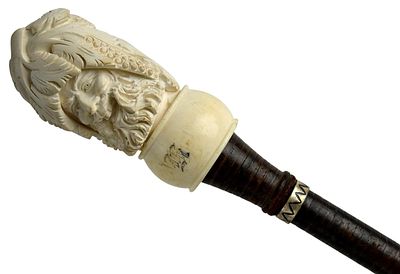 Antique Carved Face Stacked Leather Walking Stick. Antique carved face stacked leather shaft 
